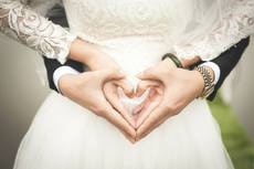 Hochzeitspaar formt Herz aus Händen